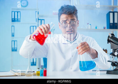 Funny mad chemist working in a laboratory Stock Photo