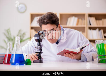 Mad crazy scientist doctor doing experiments in a laboratory Stock Photo