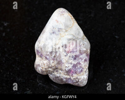 macro shooting of natural mineral rock specimen - pink Tourmaline crystals in Lepidolite mica on polished quartz stone on dark granite background from Stock Photo