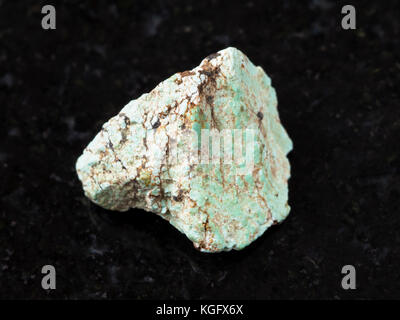 macro shooting of natural mineral rock specimen - rough green Turquoise gemstone on dark granite background Stock Photo