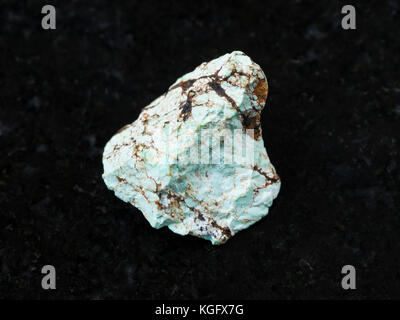 macro shooting of natural mineral rock specimen - raw green Turquoise gemstone on dark granite background Stock Photo