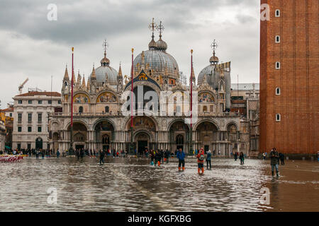 Venice, Italy. 07th November, 2017. Tourists walk in the water in St Mark square during an high tide on November 7, 2017 in Venice, Italy. Stock Photo