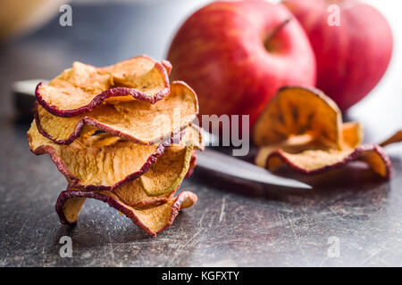 Dried apple slices on kitchen table. Stock Photo