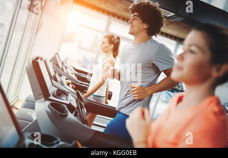Young handsome man doing cardio training in gym Stock Photo