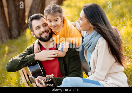 child hugging father in park Stock Photo