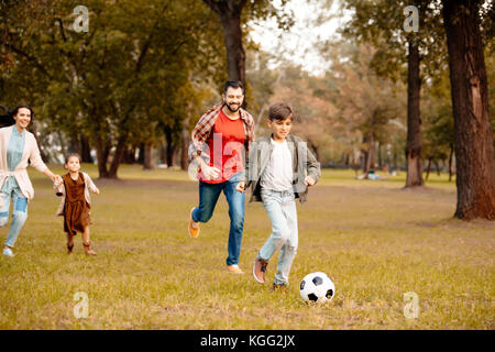 Family playing soccer Stock Photo
