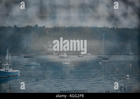 View on harbor with fishing and sailing boats through lobster net Stock Photo