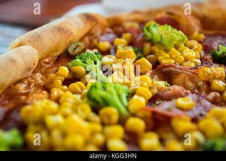 Pizza with salami, sweetcorn and broccoli Stock Photo