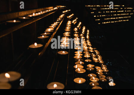 Many burning candles in a church. Stock Photo