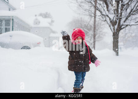 2-3 year old standing in the middle of a snow storm. Stock Photo