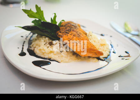 A salmon and rice dish presented plated at a restaurant. Stock Photo