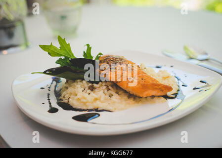 A salmon and rice dish presented plated at a restaurant. Stock Photo