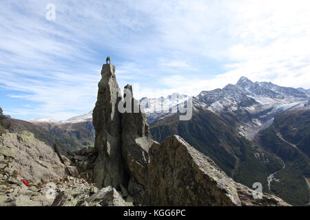 rock climbers on an extreme natural totem pole overlooking the magnificent views of the Mont Blanc in France Stock Photo