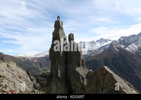 rock climbers on an extreme natural totem pole overlooking the magnificent views of the Mont Blanc in France Stock Photo