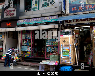 The Pettah Colombo Sri Lanka First Cross Street man at stall outside Tesco Trade Centre Stock Photo