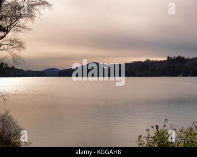 Seaplane taking off at sundown over Long Lake, New York Stock Photo