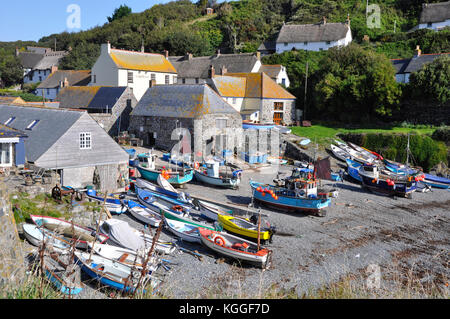 Cadgwith Cove with fishing boats hauled up on the pebble beach.Cornwall.UK Stock Photo