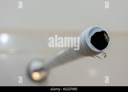 Shower water pipe mounted on wall, with a water drop coming out and thread seal teflon tape Stock Photo
