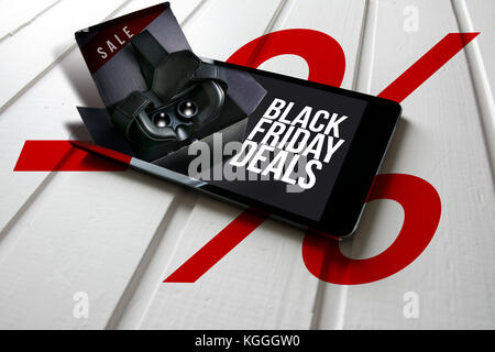 Black friday deals, promotion on computer tablet screen, box with virtual reality glasses come out of the tablet screen. Conceptual image Stock Photo