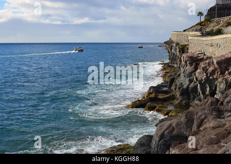 View towards the sea with part of the promenade that goes from Puerto Rico to Playa de Amadores visible. From Gran Canaria, Canary Islands Spain. Stock Photo