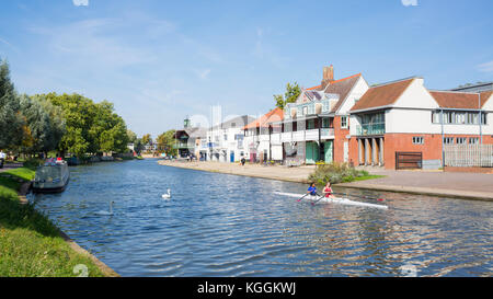 Two women students rowing on the River Cam in front of Goldie Boathouse CUBC rowing club near Midsummer Common, Cambridge England, Uk Stock Photo