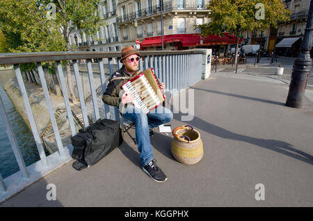 Paris, France. Pont Saint-Louis, accordion player busking Stock Photo