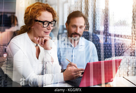 Pleasant woman making remarks on project presentation Stock Photo