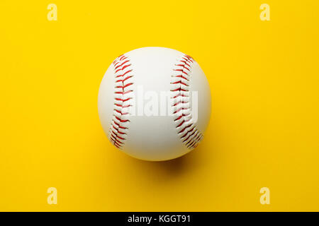 Baseball ball on yellow background with copy space Stock Photo