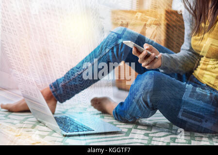 Convenient new smartphone being in the hands of a young woman Stock Photo