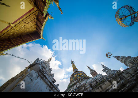 View from the bottom to the top of some roofs of Buddhist temples in Bangkok, Thailand. Stock Photo