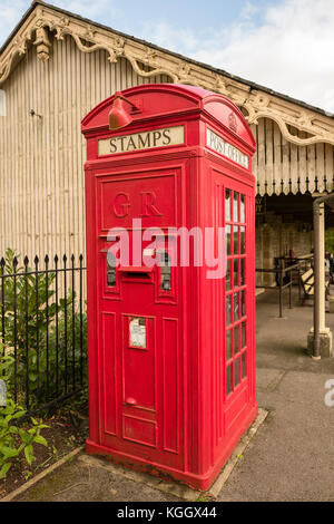 A very rare old K4 combined public telephone kiosk and vending machine for postage stamps and a serviced post box at Cranmore railway station in Somer