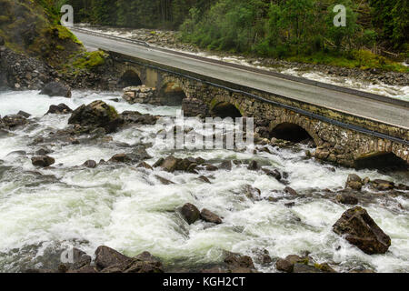 Old stone bridge. Road crossing river. Latefoss, Norway Stock Photo