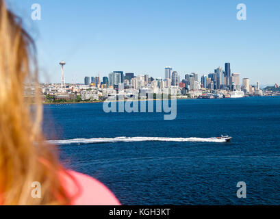 A young woman taking in the view of downtown Seattle from the deck of a cruise ship. Stock Photo