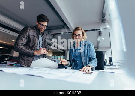 Team of architects working on building plan. business colleagues working together in office. Stock Photo