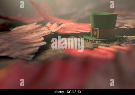 A concept image showing a tiny leprechaun hat apparently lost on the ground surrounded by dead leaves in the day time - 3D render Stock Photo