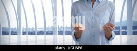 Digital composite of Businesswoman with hands palm open in city office Stock Photo