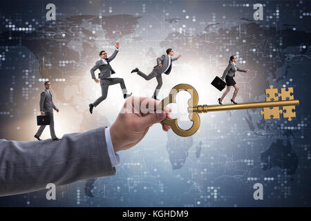 Business people chasing each other towards key to success Stock Photo