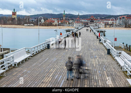 People walking on a pier (Molo) in Sopot city, Poland. Built in 1827 with 511m long it is the longest wooden pier in Europe Stock Photo