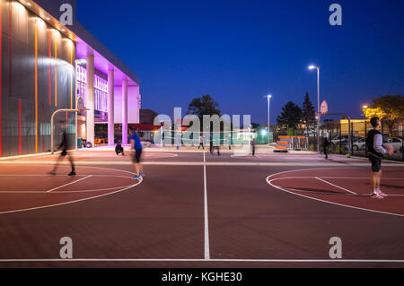 Students playing basketball and volleyball on their respective courts in front of Mohawk College's Fennel Campus in Hamilton, Ontario, Canada. Stock Photo