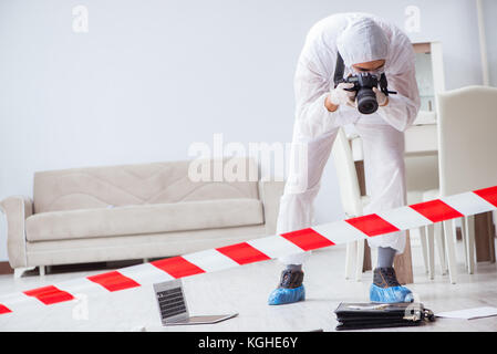Forensic expert at crime scene doing investigation Stock Photo