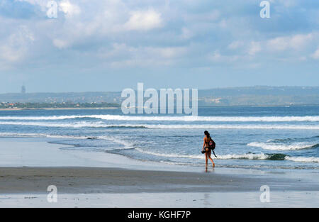 Early morning walk on Kuta beach, Bali. Stock Photo
