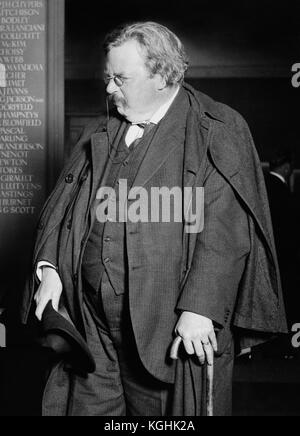 Gilbert Keith Chesterton (1874 - 1936), known as G.K. Chesterton, in 1925 with characteristic crumpled hat, cape and cane (sword-stick). Chesterton was an English writer, philosopher, dramatist, poet, journalist, orator, lay theologian, biographer, Christian apologist, and literary and art critic. He is best known for works such as Orthodoxy (1908), the Father Brown stories (1910-1935), The Everlasting Man (1925), The Man Who was Thursday (1908), and The Napoleon of Notting Hill (1904). Stock Photo