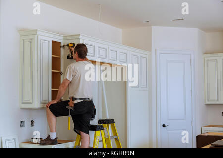 Installation of doors on kitchen cabinets Stock Photo
