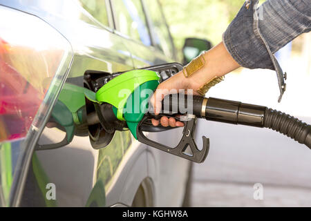 A woman's hand filling up gas Stock Photo