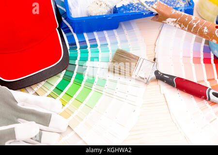 Color palette guide and painting supplies, paint brushes and color cans on wooden background Stock Photo