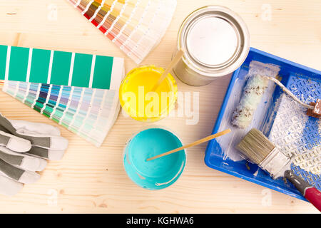 Color palette guide and painting supplies, paint brushes and color cans on wooden background Stock Photo