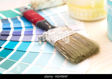 Color palette guide and painting supplies, paint brushes and color cans on wooden background Stock Photo