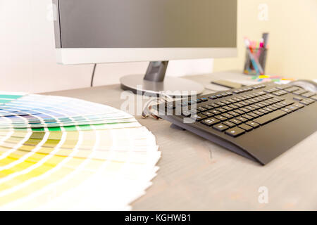 Graphic designer workplace. Color swatch samples and computer Stock Photo
