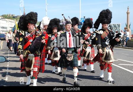 The 1066 Pipes and Drums band take part in the St. George's Day parade along the seafront at Hastings in East Sussex, England on April 27, 2009. Stock Photo