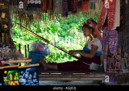 CHIANG RAI, THAILAND - NOVEMBER 4 2017: Unidentified Long Neck Karen woman making folk art goods Stock Photo